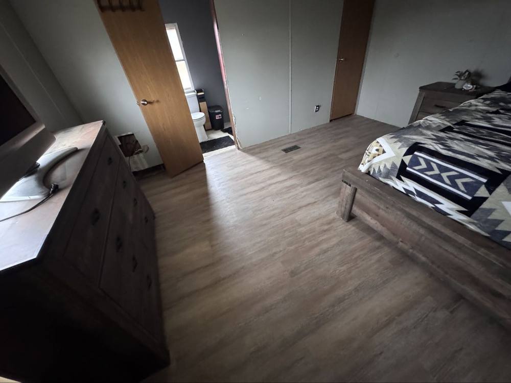 Finished bedroom floor with dresser