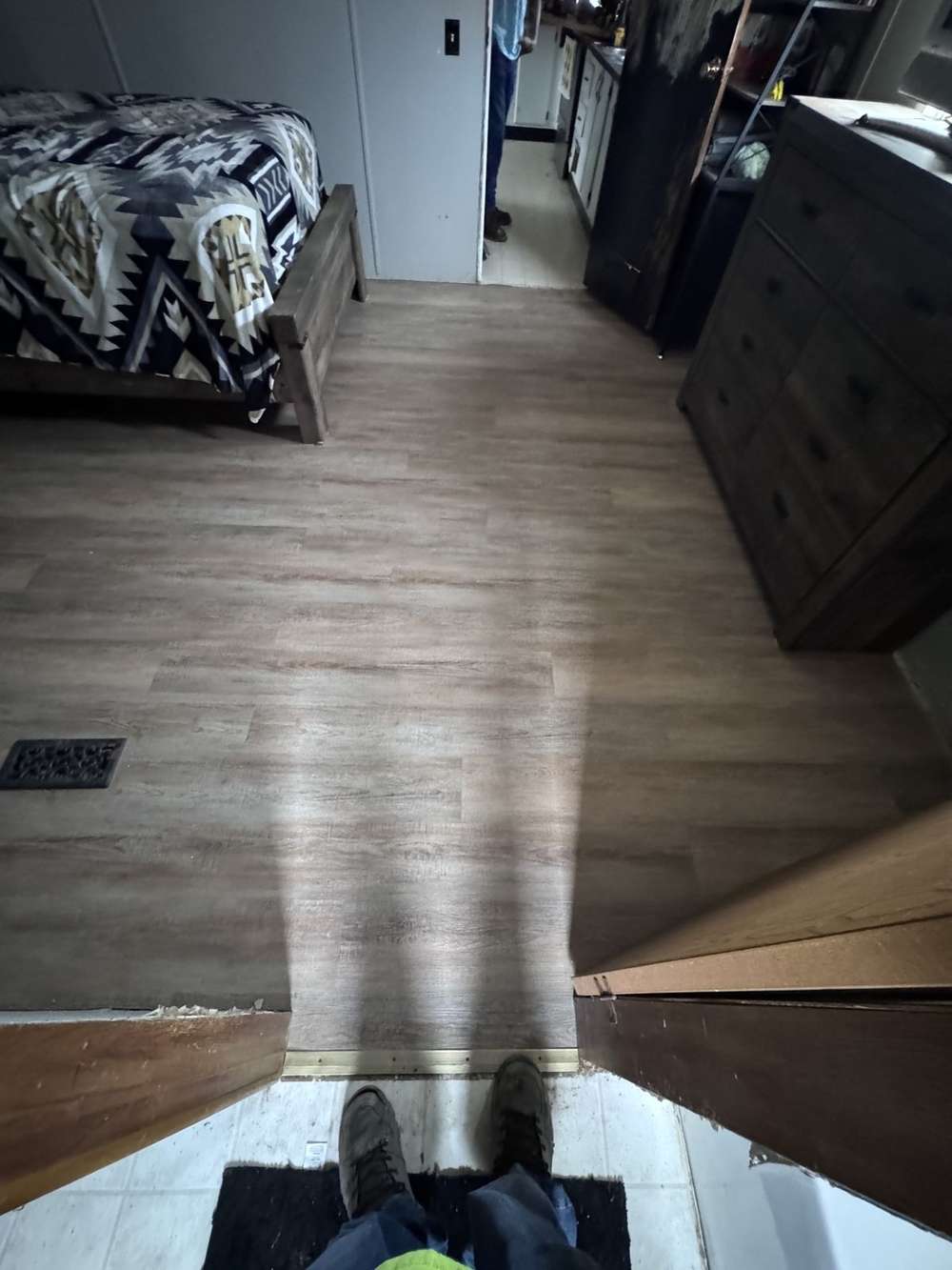 Finished vinyl plank floor running to the bathroom