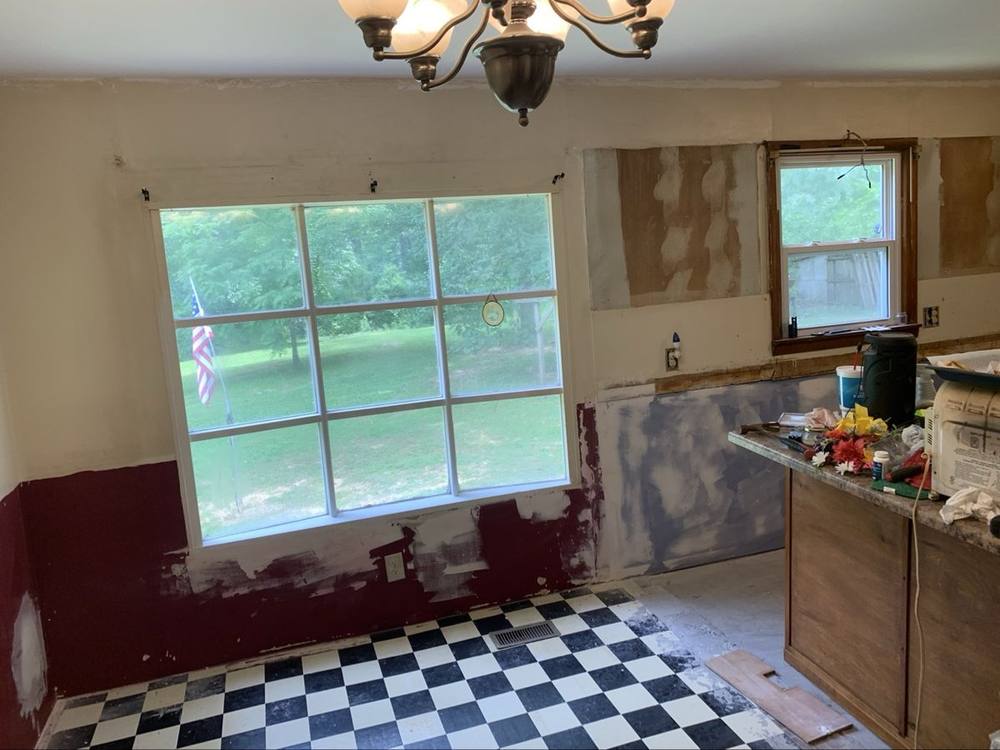 Kitchen mid-remodel with old cabinets partially removed