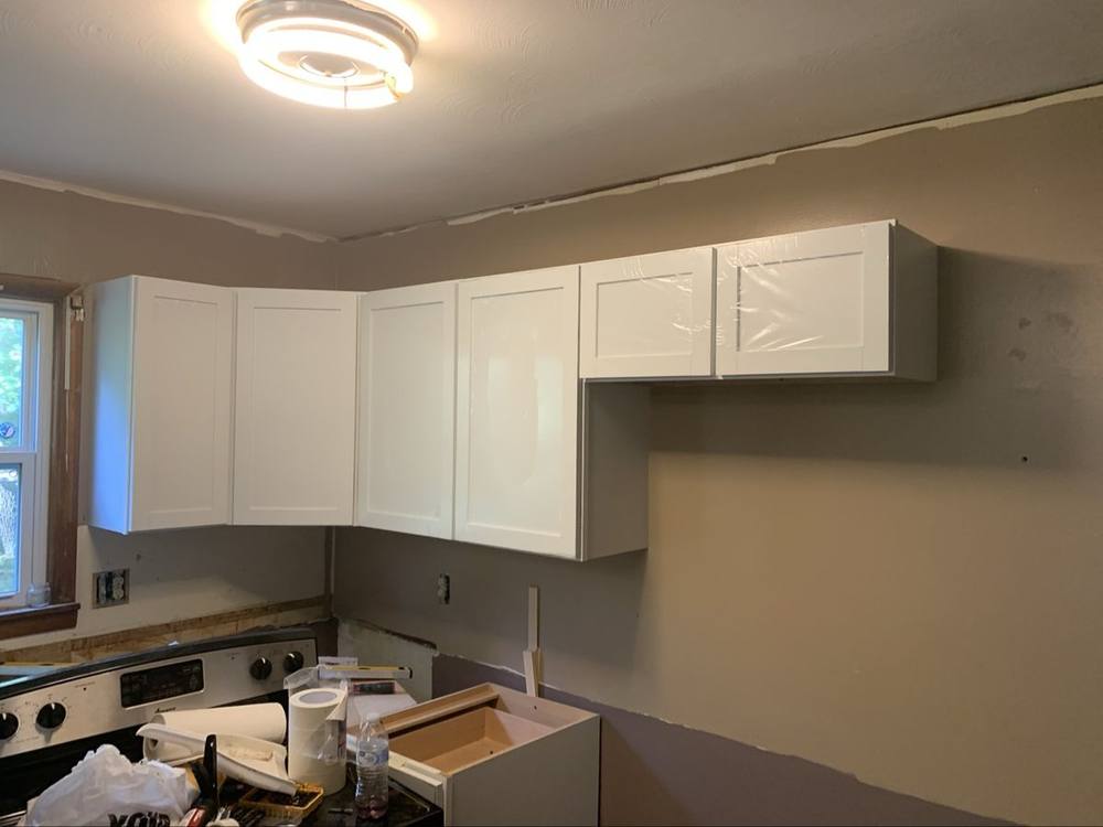New white upper cabinets being installed