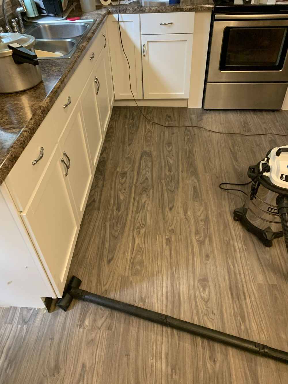 Finished kitchen sink run with white cabinets