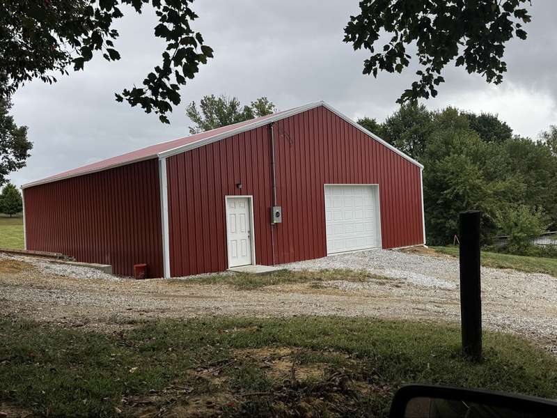 Finished pole barn with garage door installed