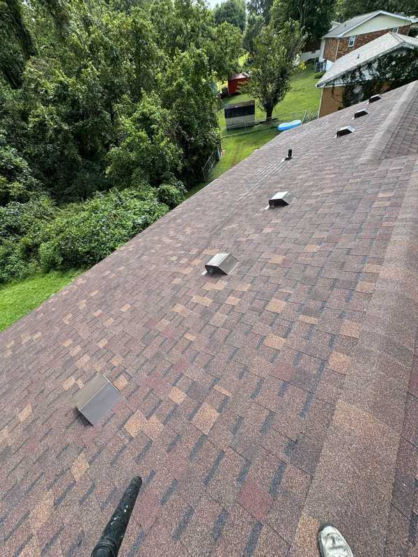 Finished shingle roof with new vents