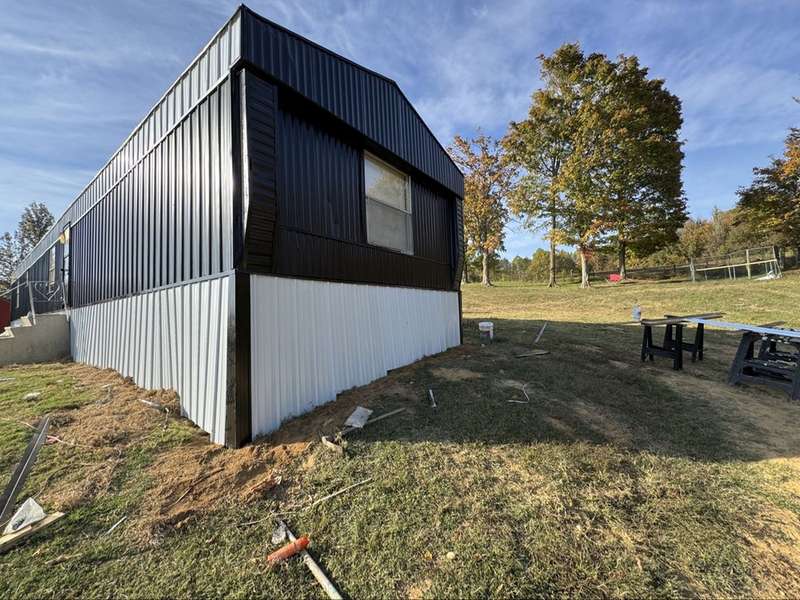 Finished black and white metal siding, corner view
